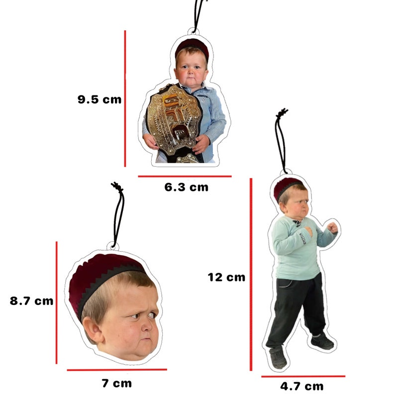 May include: Three different Christmas ornaments featuring a young boy wearing a red hat. The first ornament is 9.5 inches tall and features the boy holding a gold championship belt. The second ornament is 6.3 inches tall and features the boy standing with his arms crossed. The third ornament is 8.7 inches tall and features a close-up of the boy's face.