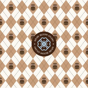 May include: A repeating pattern of brown bunny faces and diamond shapes on a cream background. The pattern is overlaid with a brown circle that says "Azure Bloom Studio" and features a blue floral design.