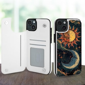 Puede incluir: Funda de teléfono de cuero blanco con borde negro, con un diseño celestial de sol y luna sobre un fondo oscuro. La funda se abre para revelar ranuras para tarjetas. La funda del teléfono está sobre una superficie de madera.
