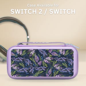 May include: A lavender Switch 2 / Switch case with a floral pattern of purple flowers and green leaves on a dark blue background. The case has a zipper closure and a handle. The text "Case Available for SWITCH 2 / SWITCH" is at the top.