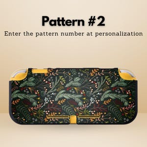 May include: A black and yellow patterned case for a handheld gaming device. The case features a botanical design with green, white, and red accents. The text "Pattern #2" and instructions are visible on the image.