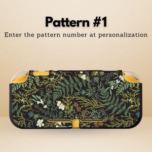 May include: A black and yellow patterned case for a handheld gaming console. The case features a botanical design with ferns, white flowers, and other foliage. The text "Pattern #1" and "Enter the pattern number at personalization" are displayed.