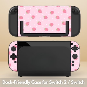 May include: Black Nintendo Switch case with a pink strawberry pattern and white polka dots. The text "Dock-Friendly Case for Switch 2 / Switch" is at the bottom of the image.