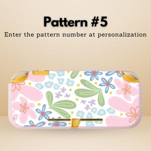 May include: A floral patterned Switch Lite case with a white background and pink, blue, green, and purple flowers. The text "Pattern #5" and "Enter the pattern number at personalization" is displayed at the top.