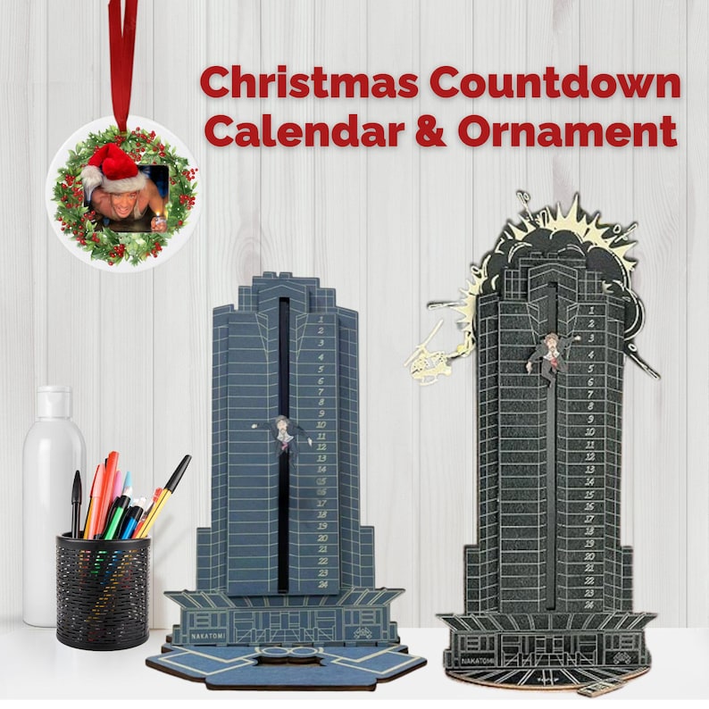 May include: Christmas countdown calendar and ornament. The image shows two skyscraper-shaped countdown calendars, one blue and one black, with a figure descending. A round ornament with a photo and Christmas wreath hangs above. Text reads "Christmas Countdown Calendar & Ornament."