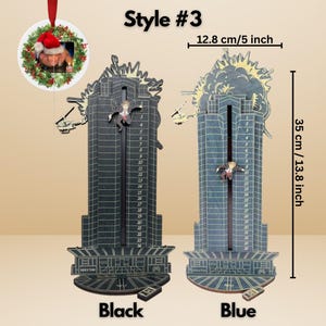 May include: Black and blue wooden Nakatomi Plaza-themed wall decor, 13.8 inches tall and 5 inches wide. Features a falling figure and explosion detail. Includes a small remote control. A Christmas ornament with a photo is also included.