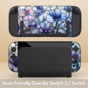 May include: A black Nintendo Switch console and dock with a floral design case. The case features blue and purple flowers with a stained-glass effect. The text at the bottom reads "Dock-Friendly Case for Switch 2 / Switch."