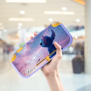 May include: A purple and yellow case featuring a blue cartoon character against a galaxy background. The case has the name "Dave" printed on it. The case is designed for a gaming device.