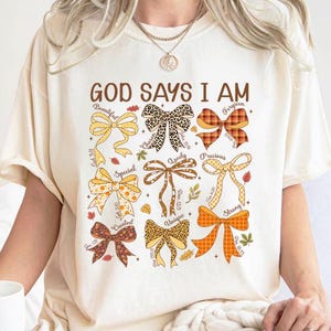 God Says I am Shirt, Coquette Fall Shirt, Cozy Halloween Shirt, Religious Thanksgiving Tee, Retro Bow Shirt, gift For Women