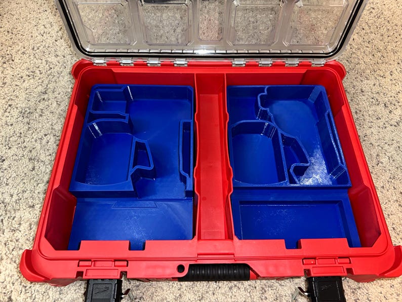May include: Red and blue plastic tool box with a removable insert. The insert has two compartments with custom cutouts for tools.