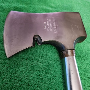 May include: A silver Stanley Shelfmaster Camp Axe with a 22 1/2 inch handle.