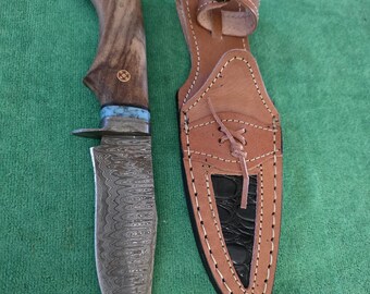 Custom handmade hunting knife with 5" blade, detailed wood handle and leather sheath. The knife for use or display.