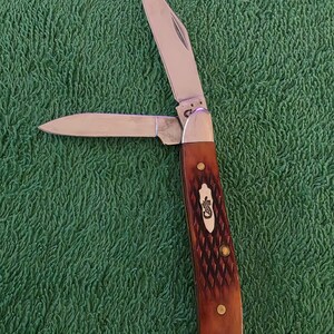 May include: A set of three ceramic mugs with a speckled, matte finish. Each mug features a different color: light blue, cream, and gray. The mugs have a simple, modern design and a comfortable handle.