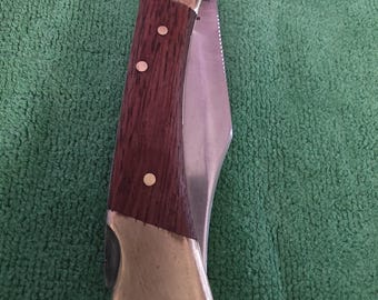 Unbranded 1980's quality folding lock blade pocket knife with 3" blade, wood and brass handles. Made in the China.