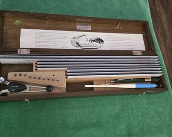 Unitech lettering guide kit with templates, misc. attachments and wooden factory case.