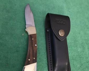 Buck 1970's Model 112 1-dot lock-blade knife with Buck 110 leather sheath. The Buck knife is made in USA.
