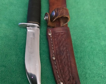 West-Cut K-5 1970's hunting knife with 5" blade leather handle and leather sheath. The hunting knife made in the USA.
