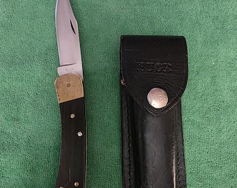 Buck 1970's Model 110 1-dot lock-blade knife with Buck leather sheath.