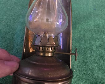 Brass and Glass oil lantern with wall mount or free standing base and removable fuel cell. The lantern approx. 6" x 4" x 4"