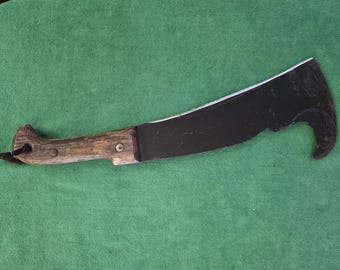 Woodsman Pal #481 machete/axe made for heavy duty use. The axe has a  wood handle.