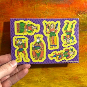 May include: A set of six colorful stickers featuring illustrations of playing card characters. The characters are a king, queen, jack, and three jesters. The stickers are on a purple background with yellow borders. The text "@thelocalstickershop" is at the bottom of the sheet.