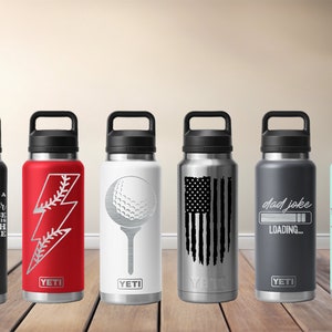 May include: Six insulated water bottles with black handles and lids. Designs include a sunflower with text, a baseball lightning bolt, a golf ball, an American flag, the words "dad joke loading," and the phrase "Suck It Up Buttercup."