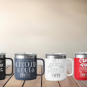 Op de afbeelding: Vier Yeti-mokken met verschillende spreuken erop. De mokken zijn zwart, blauw, wit en rood. De spreuken zijn "Better Late Than Ugly", "Officially Checked Out", "Do I Look Like a People Person?" en "Cute But Psycho".