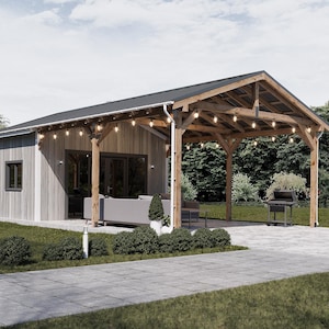 May include: A wooden outdoor structure with a dark roof and string lights. The structure has a covered patio area with a grill and seating. The building has a light gray exterior and a paved walkway.