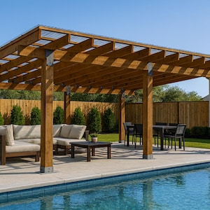 May include: A wooden pergola with a clear roof is set over a concrete patio next to a swimming pool. The pergola has a seating area with a sofa and a table, and a dining area with a table and chairs. The background includes a wooden fence and trees.