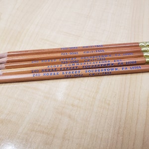 May include: A close-up of six wooden pencils with blue text. The text reads "240 Noble Street, Soudertown, PA 18964" and "723-9042 CH-7-7333".