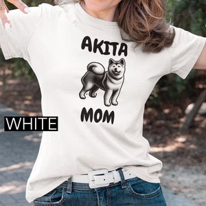 Unisex Softstyle T-Shirt. Akita dog, Dog lover, Pet parent, Dog mom, Animal affection, Paw print design, Fur baby, Dog-themed apparel