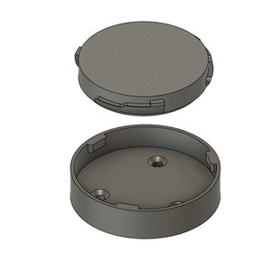 May include: A gray plastic container with a lid. The container has a round shape and a smooth surface. The lid has a slightly raised edge.