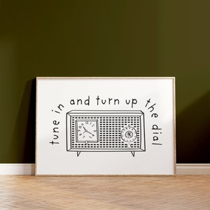 May include: A black and white illustration of a vintage radio with the text "tune in and turn up the dial".