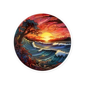 May include: A circular sticker with a colorful illustration of a sunset over a wavy ocean. The sky is a vibrant red, orange, and yellow, with a large sun in the center. A tree with green leaves is on the left side of the image, and the ocean waves are blue and white.