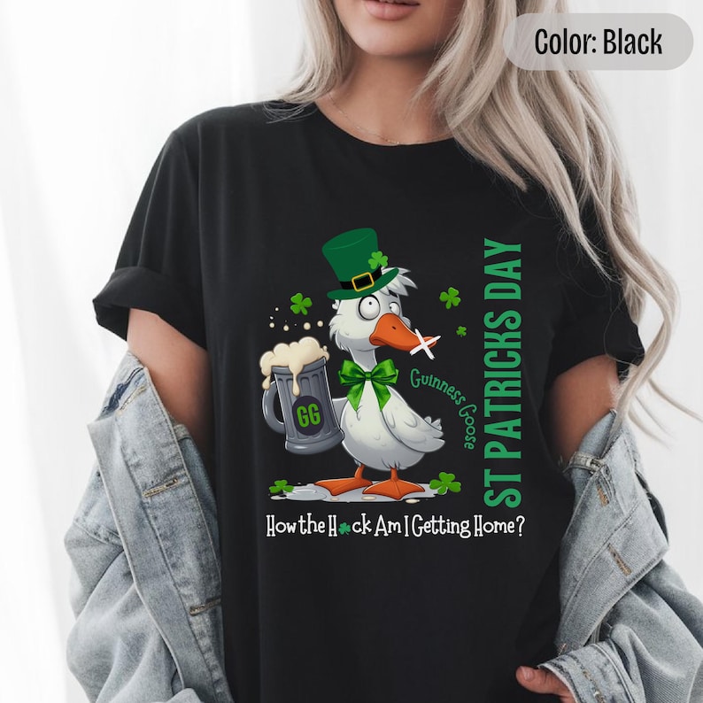 A black t-shirt featuring a cartoon goose dressed for St. Patricks Day with a green bow tie, leprechaun hat, and shamrocks. The goose, named Guinness Goose, holds a frothy beer mug labeled GG with a playful, mischievous expression. Surrounding elements include shamrocks. The words ST PATRICKS DAY are written vertically on the right, with the words How the Heck Am I Getting Home? are written horizontally below.