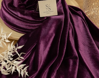 May include: A deep purple velvet fabric draped over a wooden surface. The fabric is soft and luxurious, with a subtle sheen. The fabric is labeled "Secret Spark Fabrics".
