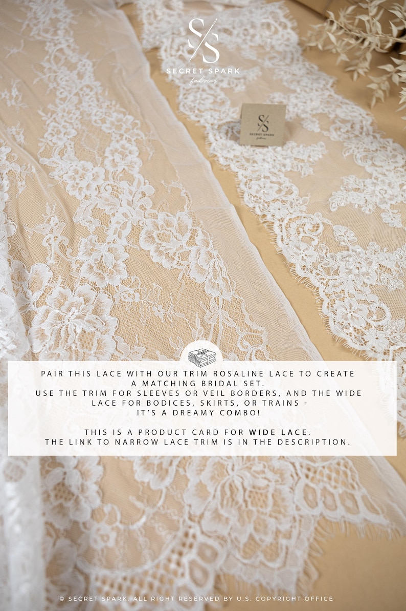 May include: White floral lace fabric with a delicate pattern, perfect for bridal wear. The image shows a close-up of the lace, with a product card and the brand logo. The lace is ideal for sleeves, veils, bodices, skirts, or trains.