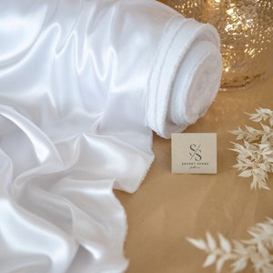 Tissu satiné blanc doux et soyeux de qualité supérieure Tissu extensible unidirectionnel pour mariage, soirée, robes légères, fiançailles, décoration | Emblématique