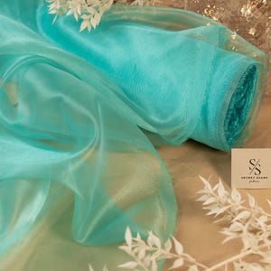 Jade Blue Crystal Organza Fabric by the Yard & Wholesale Bolt, Shiny Organza Material for Dresses and Event Wedding Decorations | Glimmer