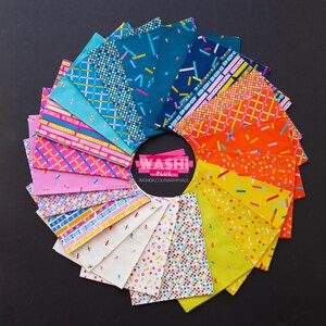 May include: A circular arrangement of colorful fabric squares with various geometric patterns. The fabrics feature designs with stripes, confetti, and abstract shapes in shades of blue, pink, orange, and yellow. The center displays the text "Washi Plus Rashida Coleman-Hale."