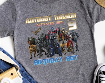 May include: Gray t-shirt with a Transformers graphic and the text "Autobot Mason Activated 2015 Age 9 Birthday Bot".