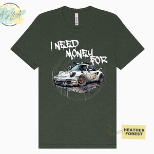 May include: A green t-shirt featuring a white sports car graphic and the text "I NEED MONEY FOR" in white graffiti-style lettering.