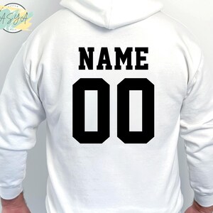 May include: White hooded sweatshirt with black text that says "NAME" and "00" on the back.