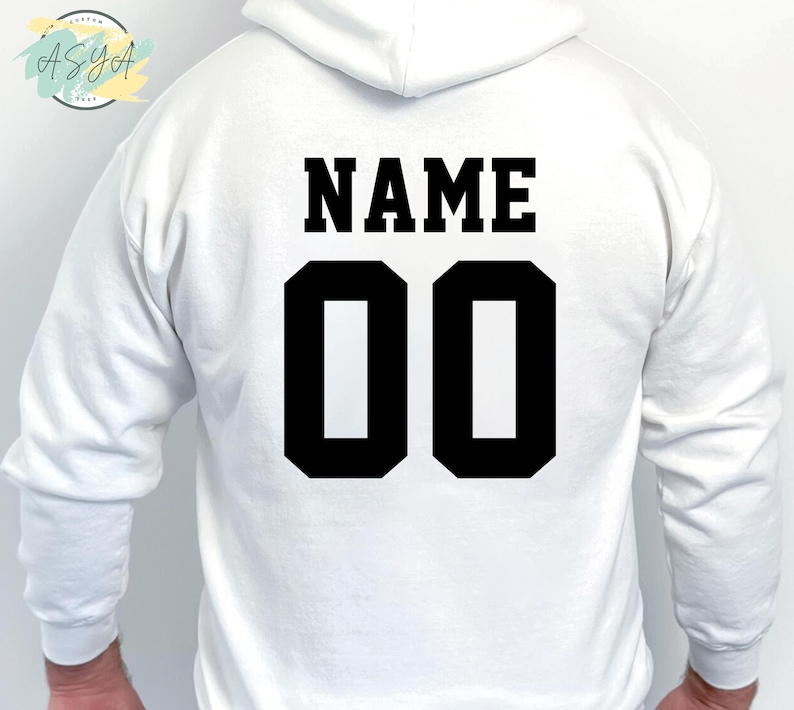May include: White hooded sweatshirt with black text that says "NAME" and "00" on the back.