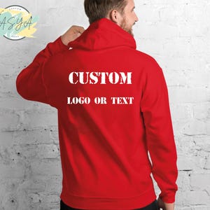 May include: Red hooded sweatshirt with the text "CUSTOM LOGO OR TEXT" printed on the back.