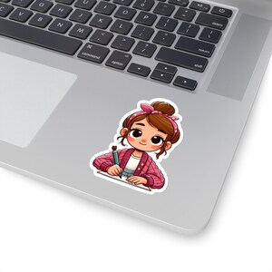 May include: A cartoon illustration of a girl with brown hair wearing a pink cardigan and a headband, sitting at a desk and drawing with a pencil.