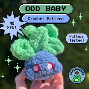 May include: A handmade crochet plushie in the shape of a blue creature with green leafy top. The plushie has red and white eyes. Text on the image reads "ODD BABY Crochet Pattern" and "NO SEW!" and "Pattern Tested!"