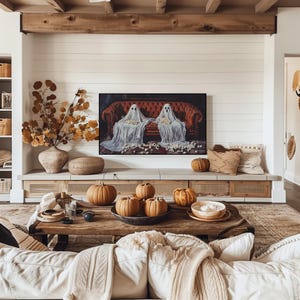 a living room filled with furniture and a painting on the wall