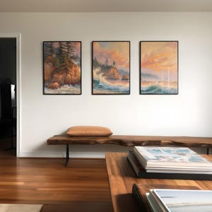 three paintings hang on the wall of a living room