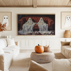 a living room filled with furniture and a painting on the wall